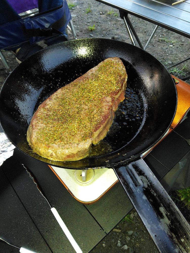 フライパンで焼かれている塊肉の写真